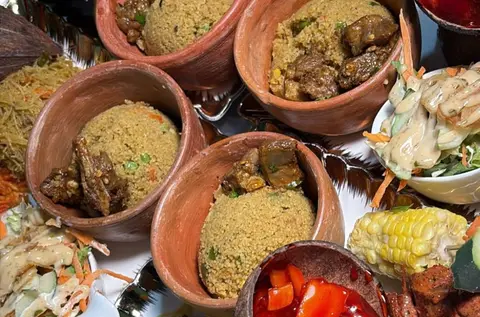 A plate of stew, greens and ugali served at a local kitchen